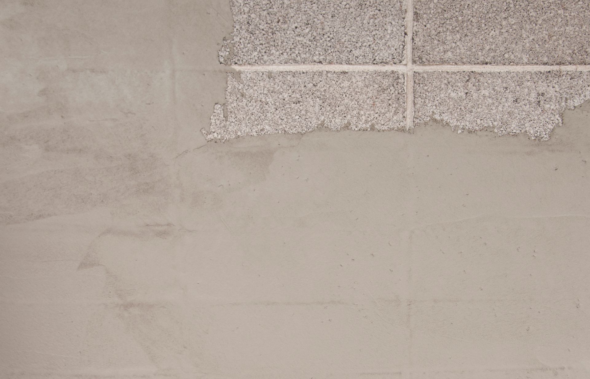 Plaster on brick wall