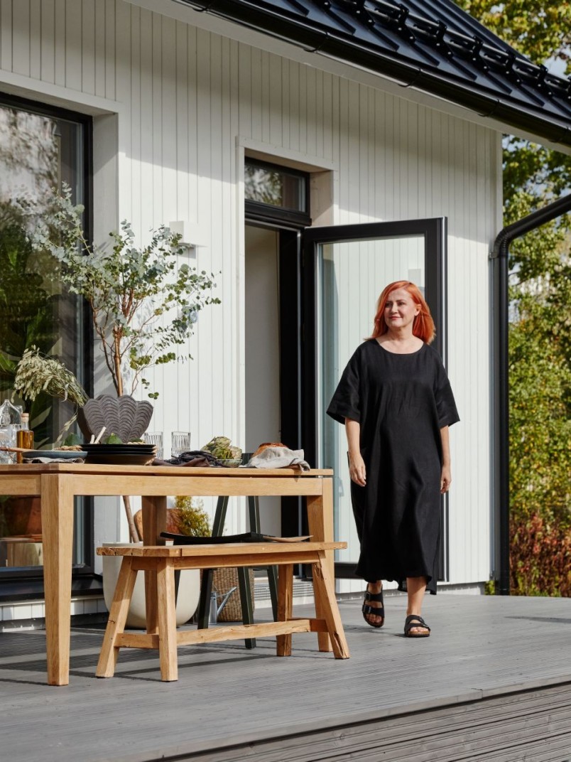 white wooden house, woman and son on terrace