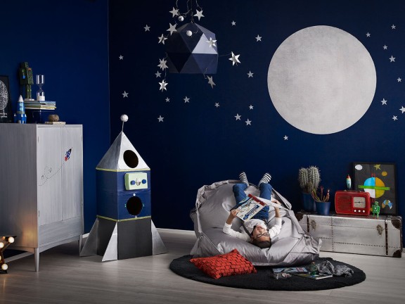 kids room with blue wall and painted with silver moon