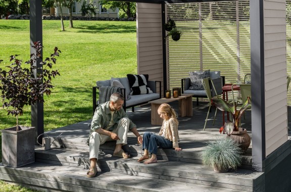 father and daughter sitting on garden deck