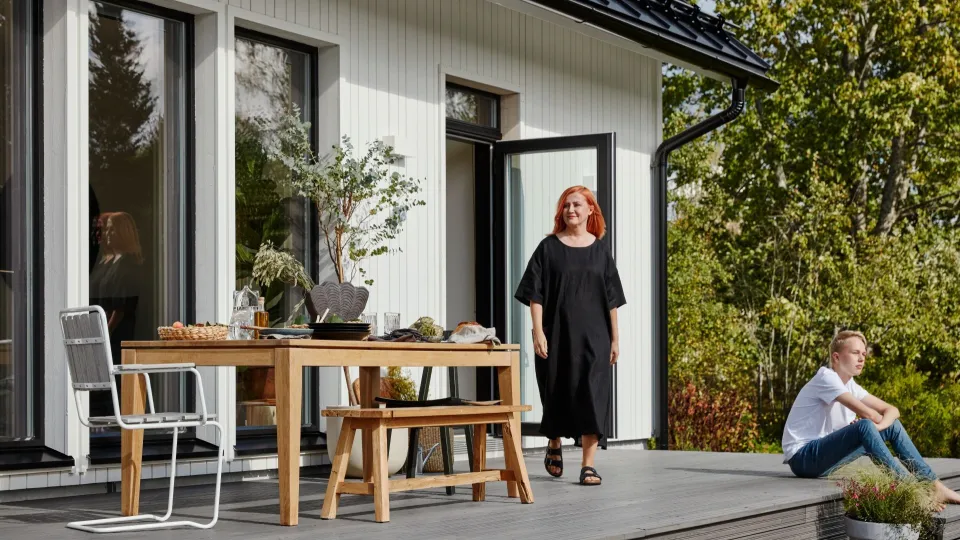 white wooden house, woman and son on terrace
