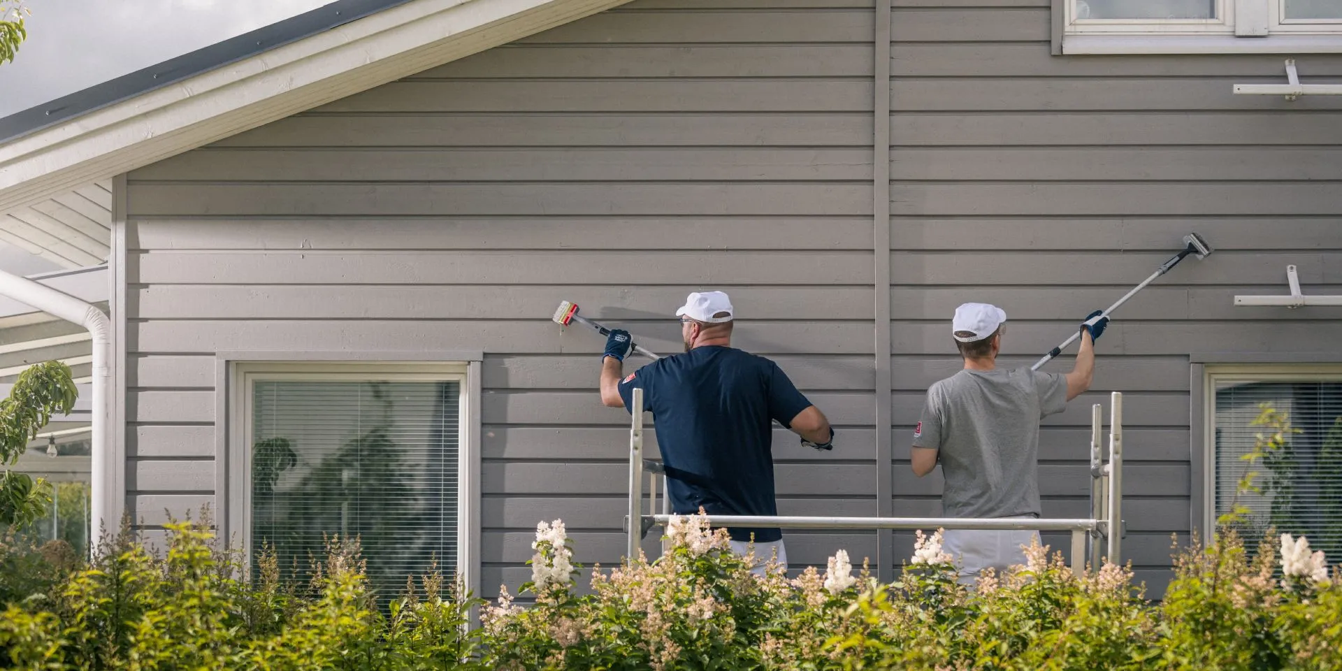Painters painting a wooden facade