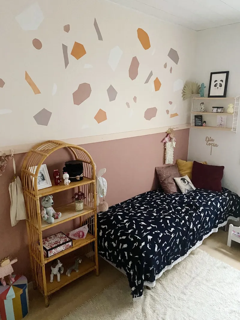 muted pink colour wall in kids room with colourful decorations